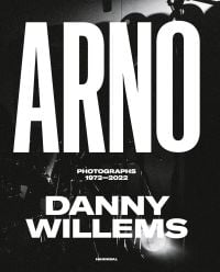 Book cover of Danny Willems' ARNO: Photographs 1972-2022, with dark stage photo and spotlight. Published by Hannibal Books.