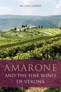 Book cover of Michael Garner's Amarone and the Fine Wines of Verona, featuring mountainous Italian vineyards with a winery in the distance. Published by Academie du Vin Library.