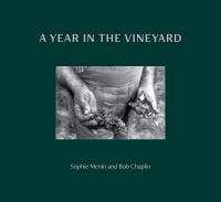Book cover of A Year in the Vineyard with worker holding secateurs and a bunch of grapes. Published by Cultureshock.