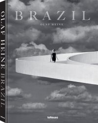 Book cover of Olaf Heine's Brazil, with a figure walking down a white raised platform on modern building, with sky behind. Published by teNeues Books.