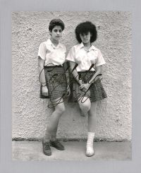 Book cover of Andrea Modica's Catholic Girl, with two school girls standing against a wall, staring at the camera. Published by L'Artiere.