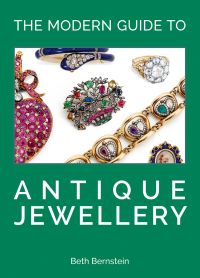 Collection of antique jewelry pieces on sage cover of 'The Modern Guide to Antique Jewellery, Beth Bernstein', by ACC Art Books.