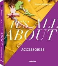 Book cover of Suzanne Middlemass's It’s All About Accessories, with a model wearing a yellow jacket and two large brooches to right lapel. Published by teNeues Books.