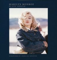 Book cover of Marilyn Monroe: By Eve Arnold, with the actress wearing denim jacket as she strikes a pose on the set of 'The Misfits', 1960. Published by ACC Art Books.