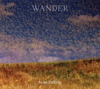 Book cover of Sean Palfrey's Wander, with a multiple exposure of green field with another field of sunflowers. Published by Hurtwood Press Ltd.