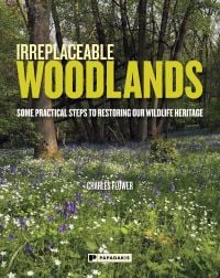 Book cover of Charles Flower's Irreplaceable Woodlands: Some Practical Steps to Restoring our Wildlife Heritage, with a woodland with bluebells. Published by Papadakis.