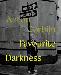Book cover of Favourite Darkness: Anton Corbijn, featuring a man standing behind a street sign. Published by Hannibal Books.