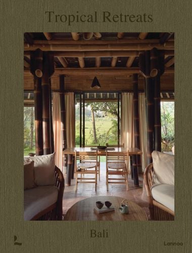 Book cover of Tropical Retreats; featuring an interior living space with wood furniture and bamboo beams. Published by Lannoo Publishers.
