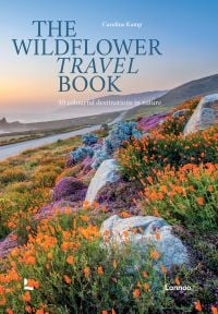 Book cover of The Wildflower Travel Book: 50 Colourful Destinations in Nature; featuring a vibrant coastal scene with blooming orange and purple wildflowers along a winding road. Published by Lannoo Publishers.