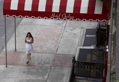 Book cover of Hotel Chelsea, with an aerial view of person walking under the striped marquee of a hotel entrance. Published by Pointed Leaf Press.