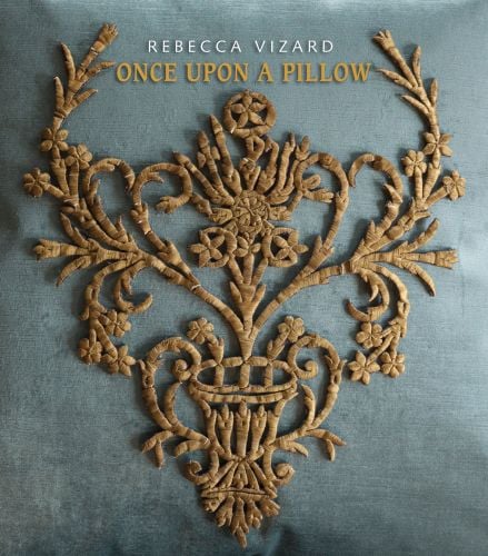 Book cover of Once Upon a Pillow, with a embroidered, gold crest on cushion. Published by Pointed Leaf Press.