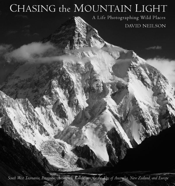 Book cover of Chasing the Mountain Light: A Life Photographing Wild Places, with a snow covered mountain landscape. Published by Abbeville Press.