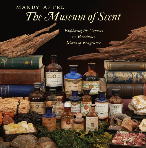 Book cover of The Museum of Scent, Exploring the Curious and Wondrous World of Fragrance, with a collection of antique perfume bottles surrounded by old books and chunks of wood. Published by Abbeville Press.