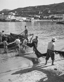 Young boy sitting on bow of boat, on cover of 'Greece After the War, Years of Hope', by Abbeville Press.