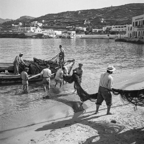 Young boy sitting on bow of boat, on cover of 'Greece After the War, Years of Hope', by Abbeville Press.