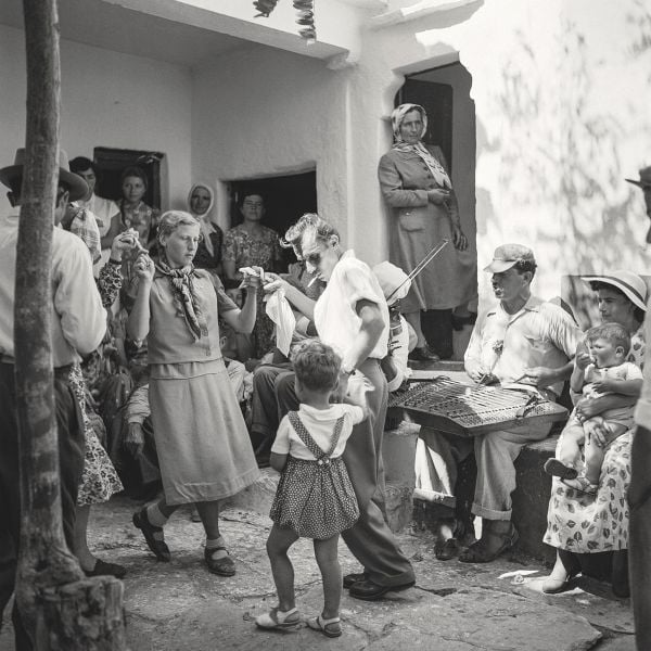Young boy sitting on bow of boat, on cover of 'Greece After the War, Years of Hope', by Abbeville Press.