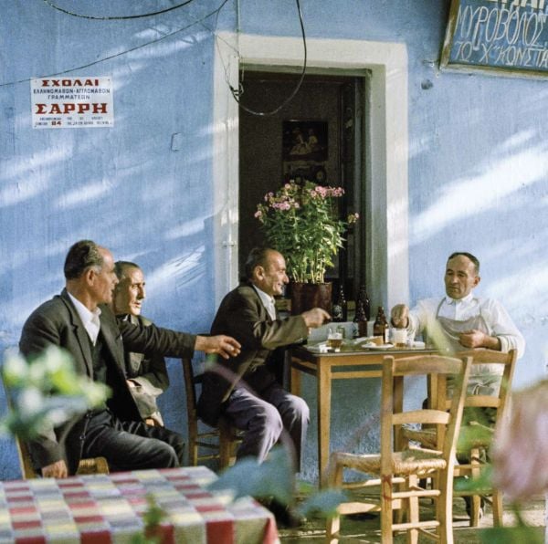 Young boy sitting on bow of boat, on cover of 'Greece After the War, Years of Hope', by Abbeville Press.