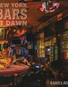 Book cover of New York Bars at Dawn, with the dark interior of 7B Horseshoe Bar aka Vazacs with juke box. Published by Abbeville Press.