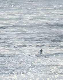 Book cover of Marguerite Horner's Numinous, with watercolor of seascape with figure on paddleboard. Published by Hurtwood Press Ltd.