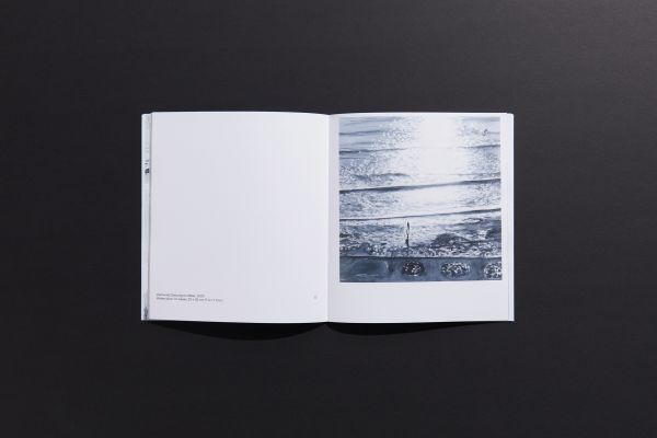 Book cover of Marguerite Horner's Numinous, with watercolor of seascape with figure on paddleboard. Published by Hurtwood Press Ltd.