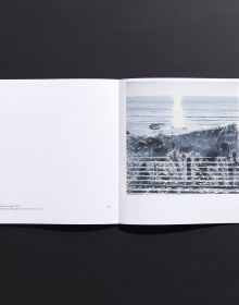 Book cover of Marguerite Horner's Numinous, with watercolor of seascape with figure on paddleboard. Published by Hurtwood Press Ltd.