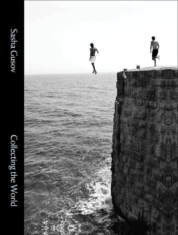 Book cover of Collecting the World, featuring a photo capturing a figure jumping off edge of brick structure into sea below. Published by Hurtwood Press Ltd.