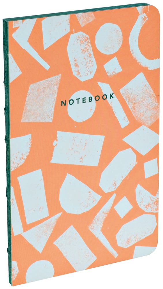 Terracotta cover with small off white block print shapes spread over front and back with notebook in dark font in centre