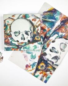 Puzzle box cover of Paul Cezanne, Skull on a Curtain 1000-Piece Puzzle, featuring the artist's 'Skull on a Curtain' artwork. Published by teNeues Stationery.