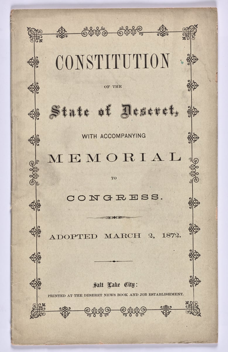 Yellowed newspaper document headed We the people of the United States, on blue cover, COLONISTS, CITIZENS, CONSTITUTIONS in gold font above.