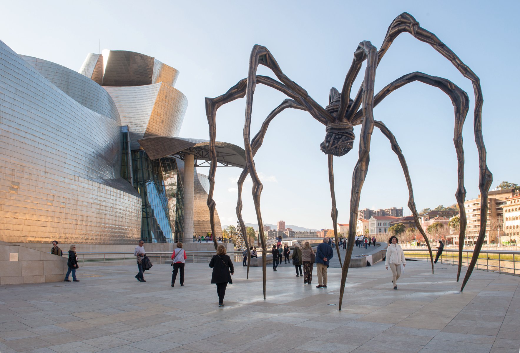 Close up of rusted steel sculpture, The Matter of Time by Richard Serra, GUGGENHEIM MUSEUM BILBAO in white font to centre right.