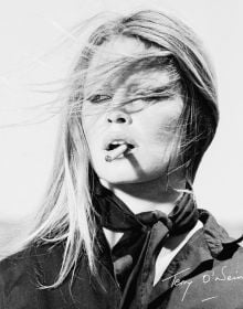 Bridgitte Bardot with windswept hair, smoking, on cover of 'Terry O’Neill, The Opus', by ACC Art Books.
