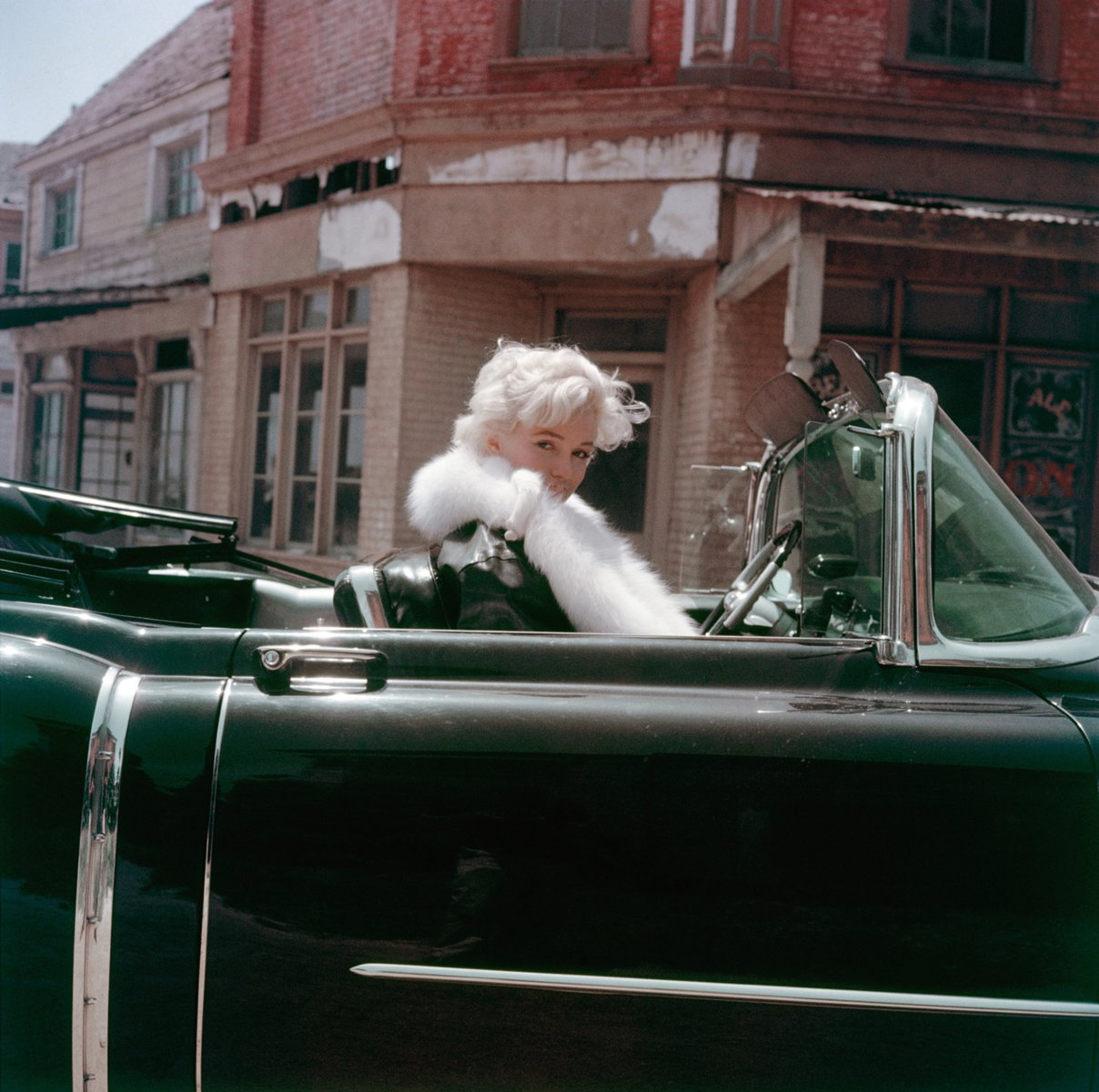 Book cover of The Essential Marilyn Monroe, featuring the actress posing for the negligee Sitting, by Milton H. Greene. Published by ACC Art Books.