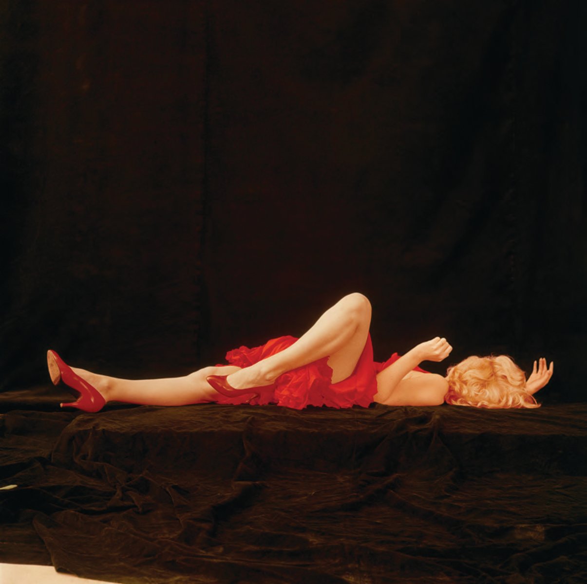 Marilyn Monroe - Negligee Sitting, by Milton H. Greene, on black cover of 'The Essential Marilyn Monroe', by ACC Art Books.