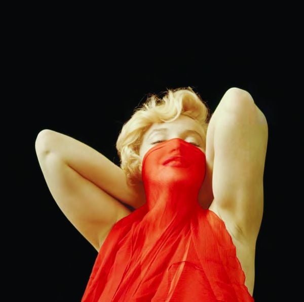 Book cover of The Essential Marilyn Monroe, featuring the actress posing for the negligee Sitting, by Milton H. Greene. Published by ACC Art Books.