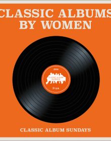 Black vinyl record, to centre of orange cover of 'Classic Albums by Women', by ACC Art Books.