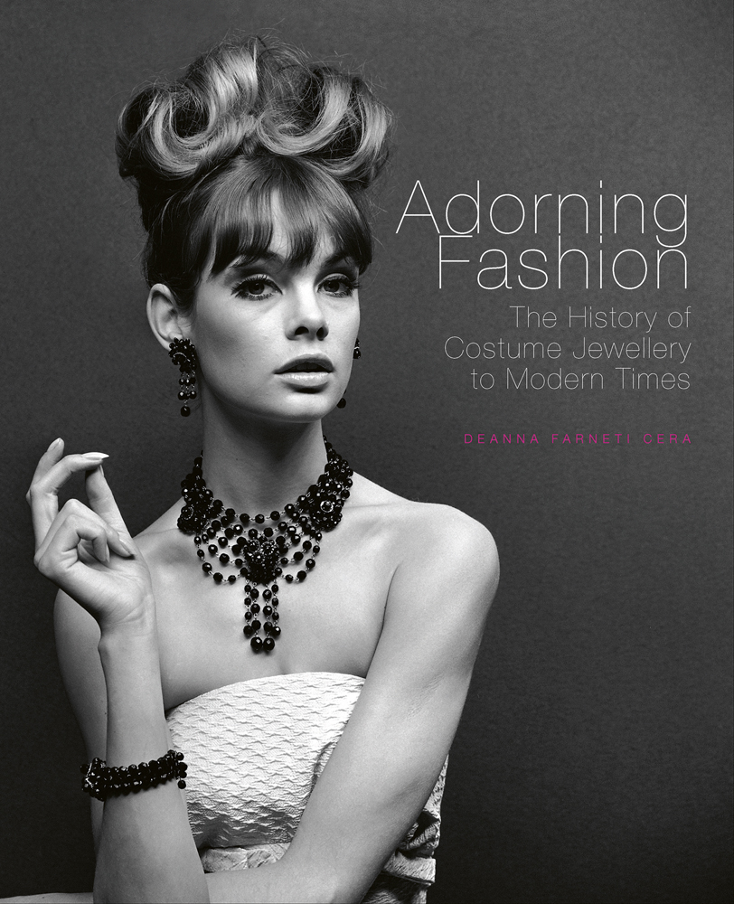 Book cover of Adorning Fashion: The History of Costume Jewellery to Modern Times, featuring Jean Shrimpton modelling large beaded jewellery for ‘Voice & Vision’, John French, 1963. Published by ACC Art Books.