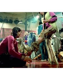 'STONES' in stencilled font with Rolling Stones members behind, on red cover of 'Stones From the Inside – The Limited Edition, Rare and Unseen Images', by ACC Art Books.