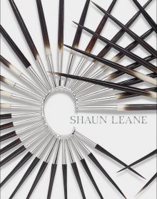 Spiked metal and wood ear cuff, on white cover of 'Shaun Leane', by ACC Art Books.