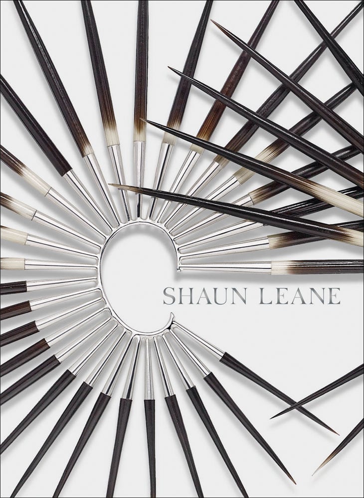 Spiked metal and wood ear cuff, on white cover of 'Shaun Leane', by ACC Art Books.