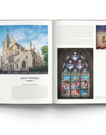 Gothic interior of Sainte-Chapelle in Paris, stained glass windows with fleurs de lys ceiling decoration, to cover of 'Churches of Paris', by ACC Art Books.