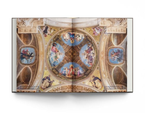 Book cover of Churches of Paris, featuring the atmospheric gothic interior of Sainte-Chapelle in Paris, and stained glass windows with fleurs de lys ceiling decoration. Published by ACC Art Books.