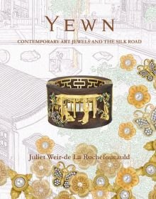 Reclaimed wood bangle, yellow Sapphire set in 18K yellow gold, on embroidered floral cover, 'YEWN', in brown font above, by ACC Art Books.