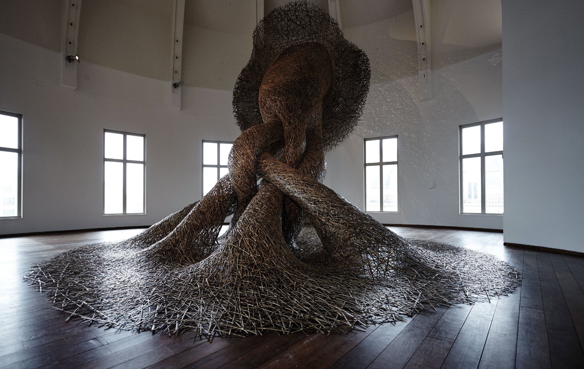 Book cover of Tanabe Chikuunsai IV Masterpieces in Bamboo, featuring a large wave-like installation sculpture made of bamboo. Published by ACC Art Books.
