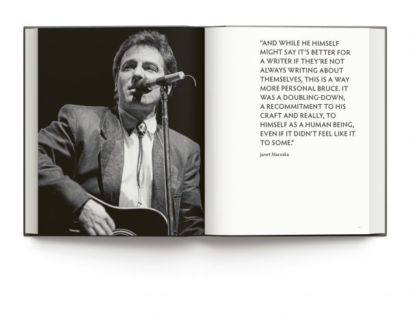 Book cover of Bruce Springsteen Live in the Heartland, featuring the singer songwriter wearing a bandana while playing electric guitar on stage,. Published by ACC Art Books.