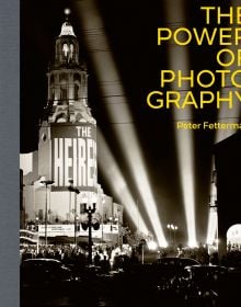 Black and white photograph of an architectural theatre at night with ground studio spotlights lighting up a full car park and queuing crowd with The Power of Photography Peter Fetterman in grey and white by ACC Art Books