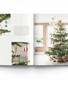 Nordic style white interior with green Christmas tree, on cover of 'The Christmas Season, Created By Scandinavian Artists', by ACC Art Books.