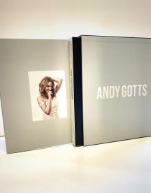 Scarlett Johansson smirking at camera, on black cover of 'Andy Gotts The Photograph; Kylie Minogue Deluxe Edition', by ACC Art Books.