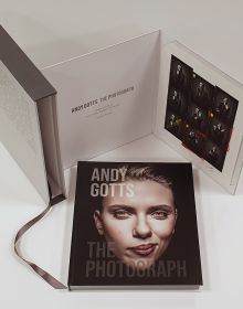 Scarlett Johansson smirking at camera, on black cover of 'Andy Gotts The Photograph; Ringo Starr Deluxe Edition', by ACC Art Books.