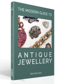 Collection of antique jewellery pieces on sage cover of 'The Modern Guide to Antique Jewellery, Beth Bernstein', by ACC Art Books.