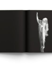 Blurred female nude in movement, on black cover of 'Memory of Light, Steen Evald', by ACC Art Books.